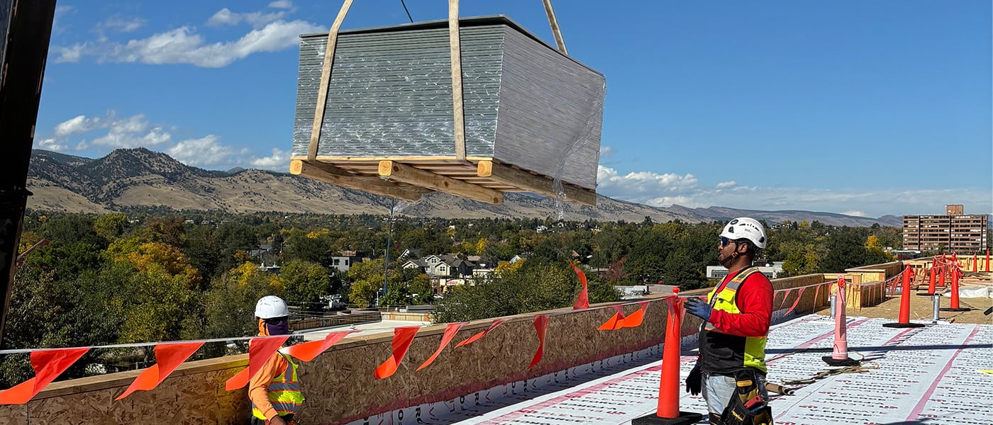 Modern student housing buildings at The Standard at Boulder development near the University of Colorado Boulder, featuring contemporary architecture and landscaped outdoor spaces.