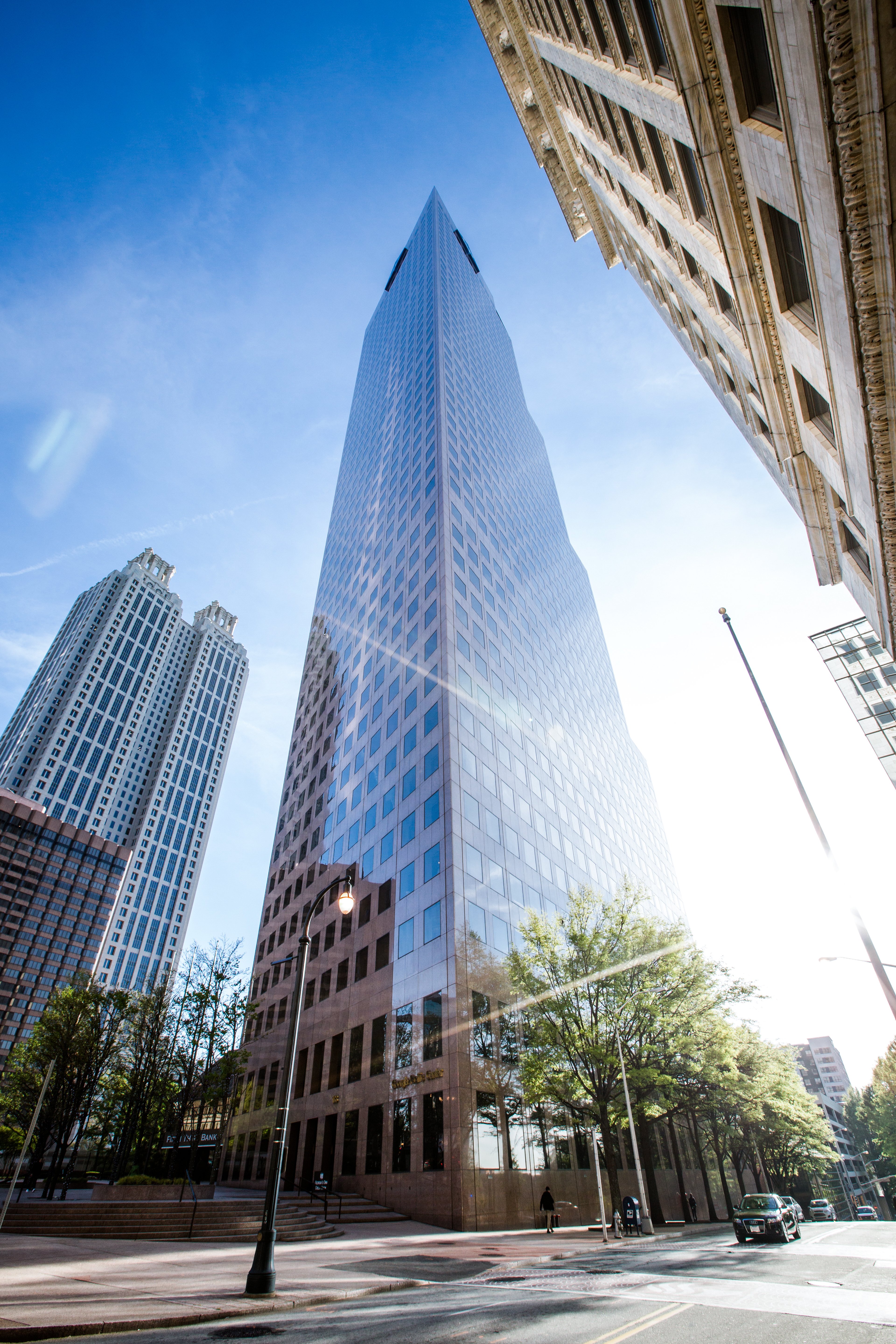 Exterior view of the Georgia-Pacific Center skyscraper featuring reflective glass architecture against a blue sky in downtown Atlanta.